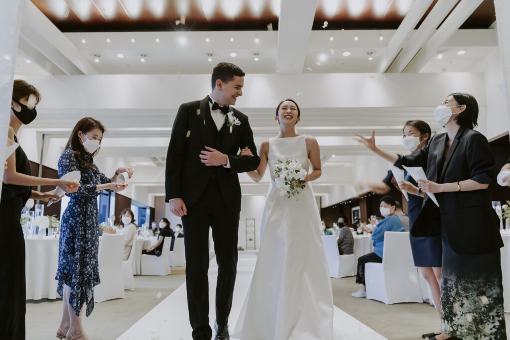 A bride and groom walking down the aisle at their wedding in Seoul.