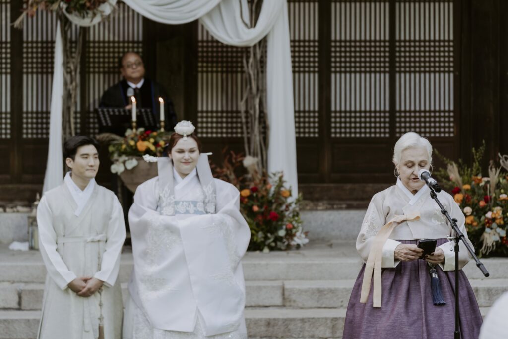 A woman dressed in Korean hanbok gives a speech at a Korean Wedding in Seoul