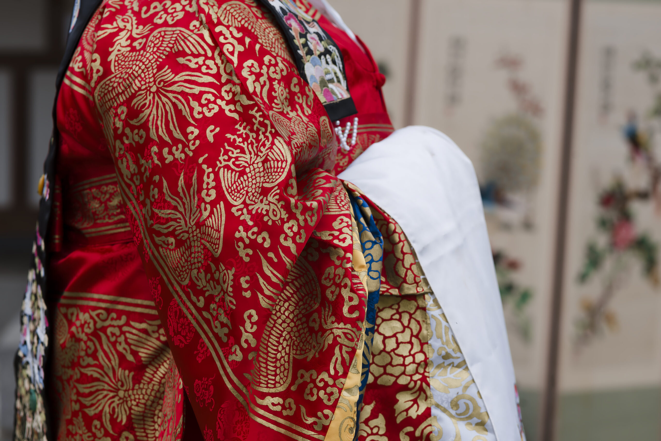 the red and gold hanbok of the bride