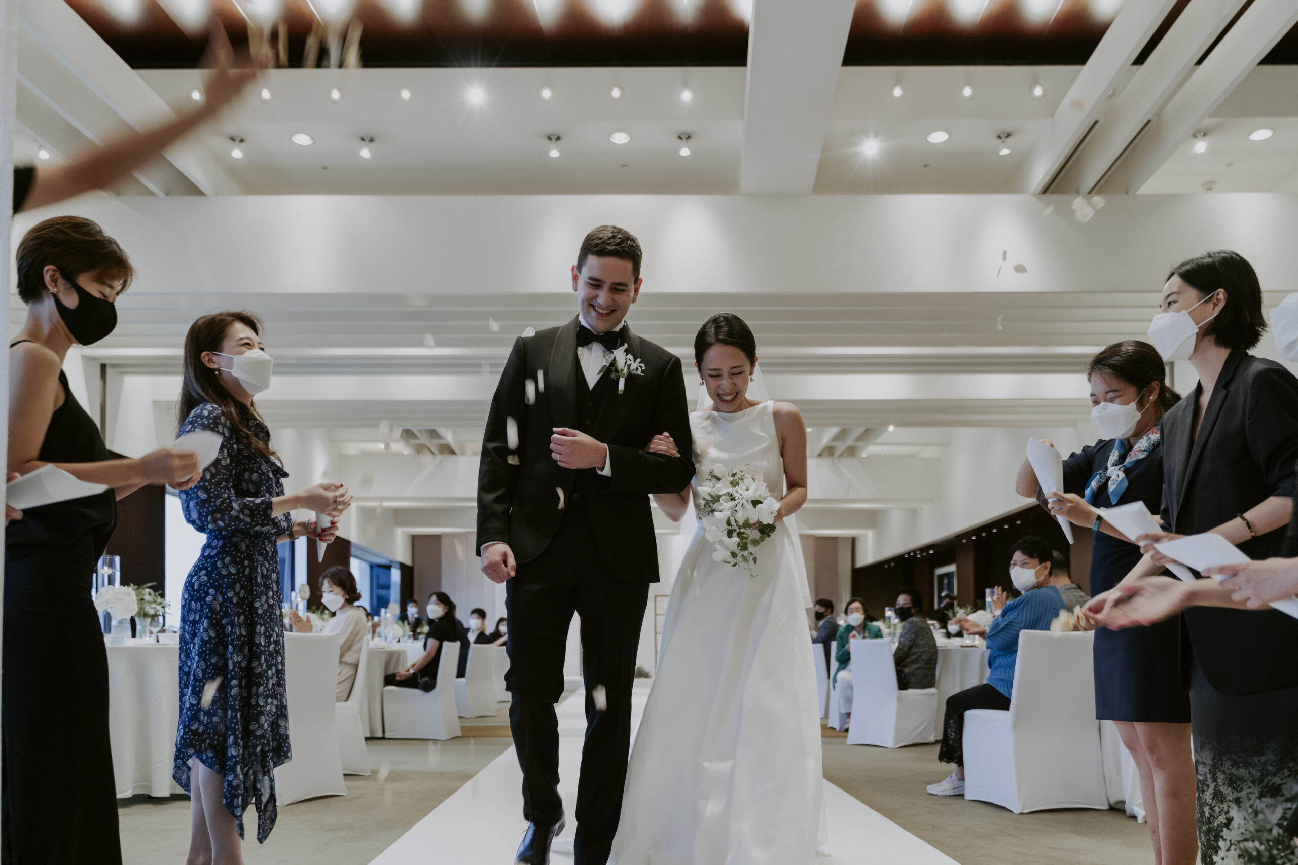 A bride and groom walking down the aisle at their wedding in Seoul, part of them planning a wedding in Korea.