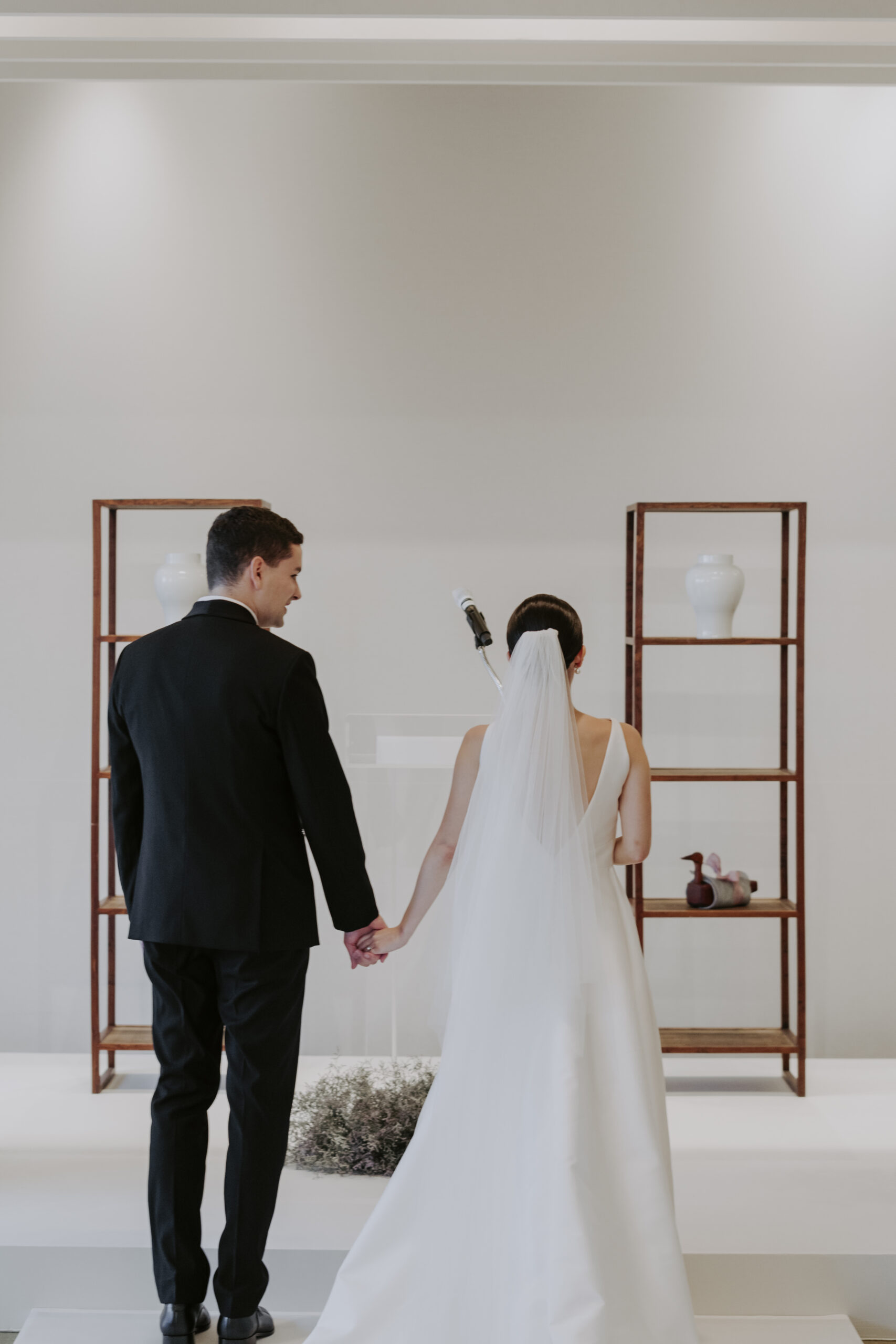 A bride and groom walking down the aisle at a wedding, part of them planning a wedding in Korea.