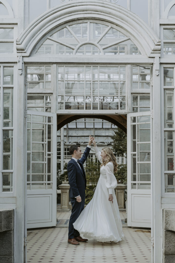 Seoul elopement couple posing in front of a greenhouse.