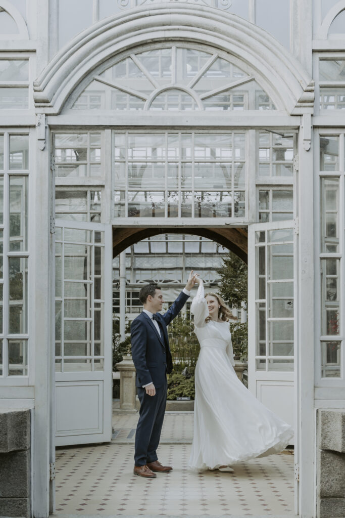 Seoul newlyweds elegantly dancing in a serene greenhouse during their elopement.