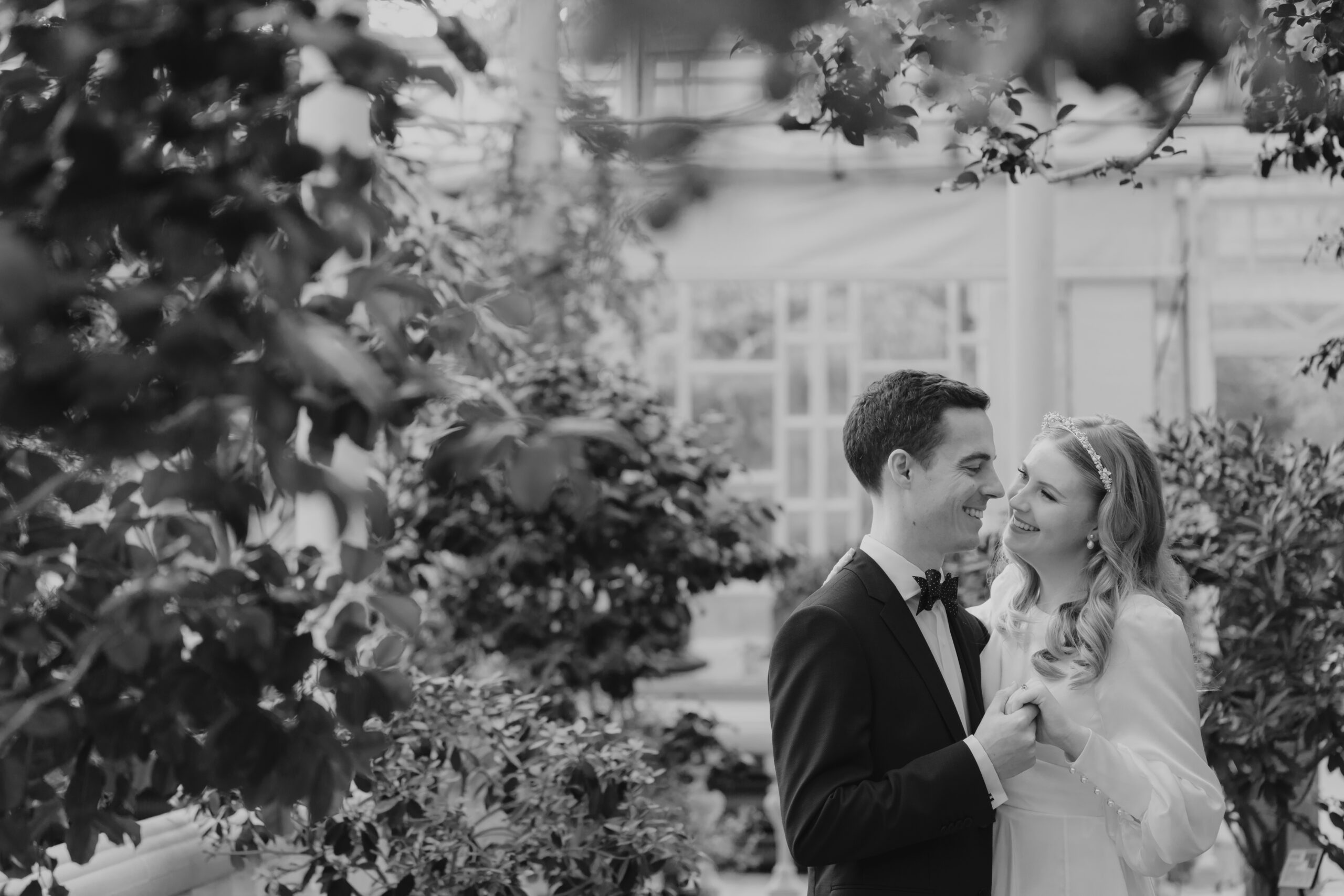 Black and white photo of a bride and groom in a Seoul greenhouse elopement.