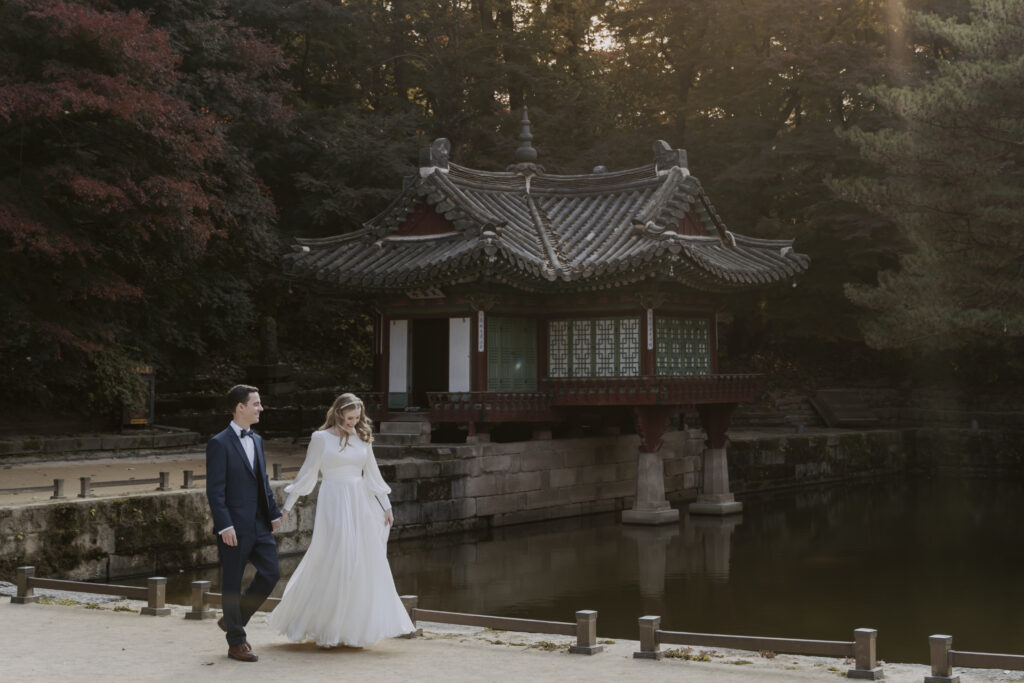 A Seoul elopement featuring a bride and groom in front of a pagoda.