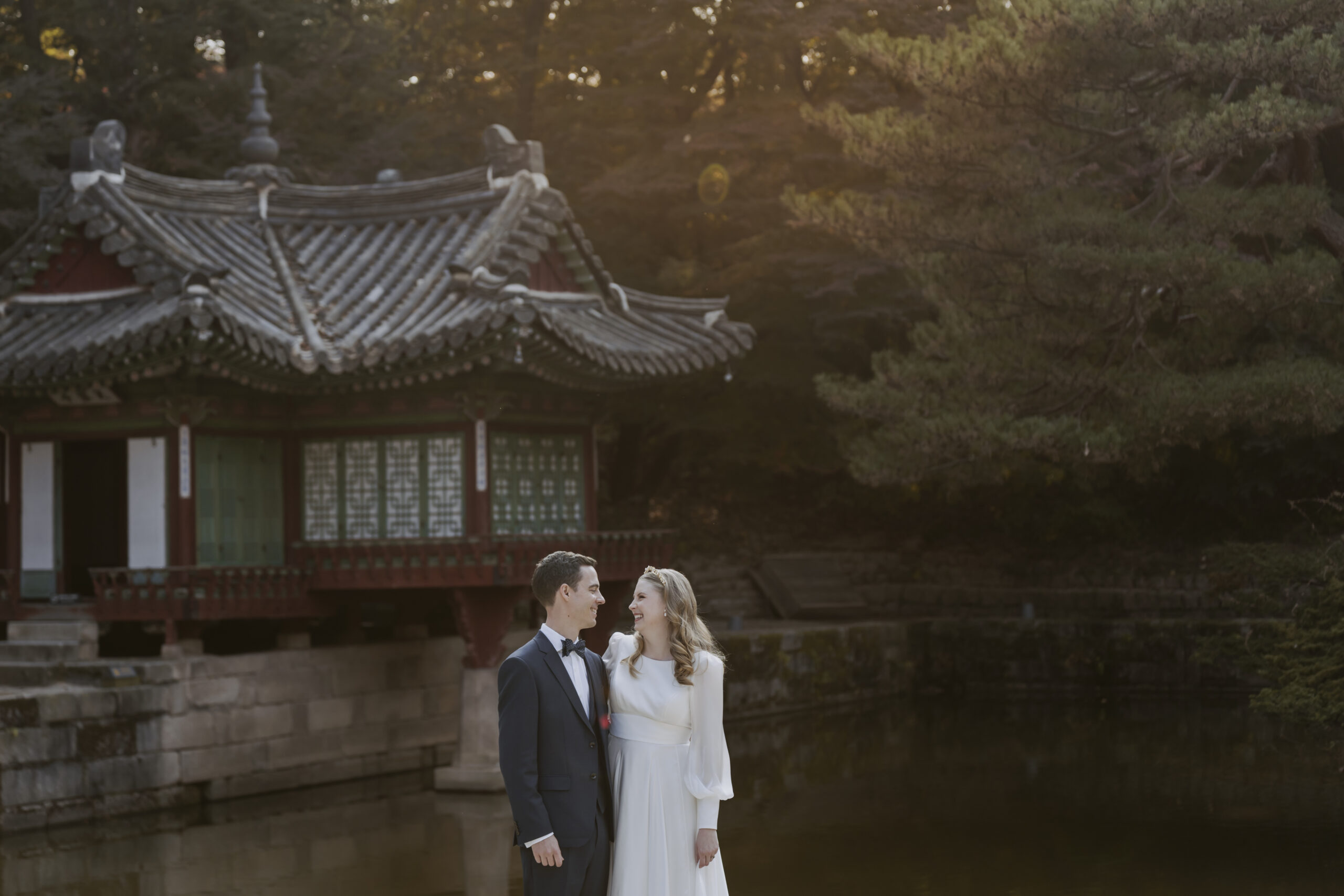 A bride and groom standing in the secret garden in Changdeokgung Palace.