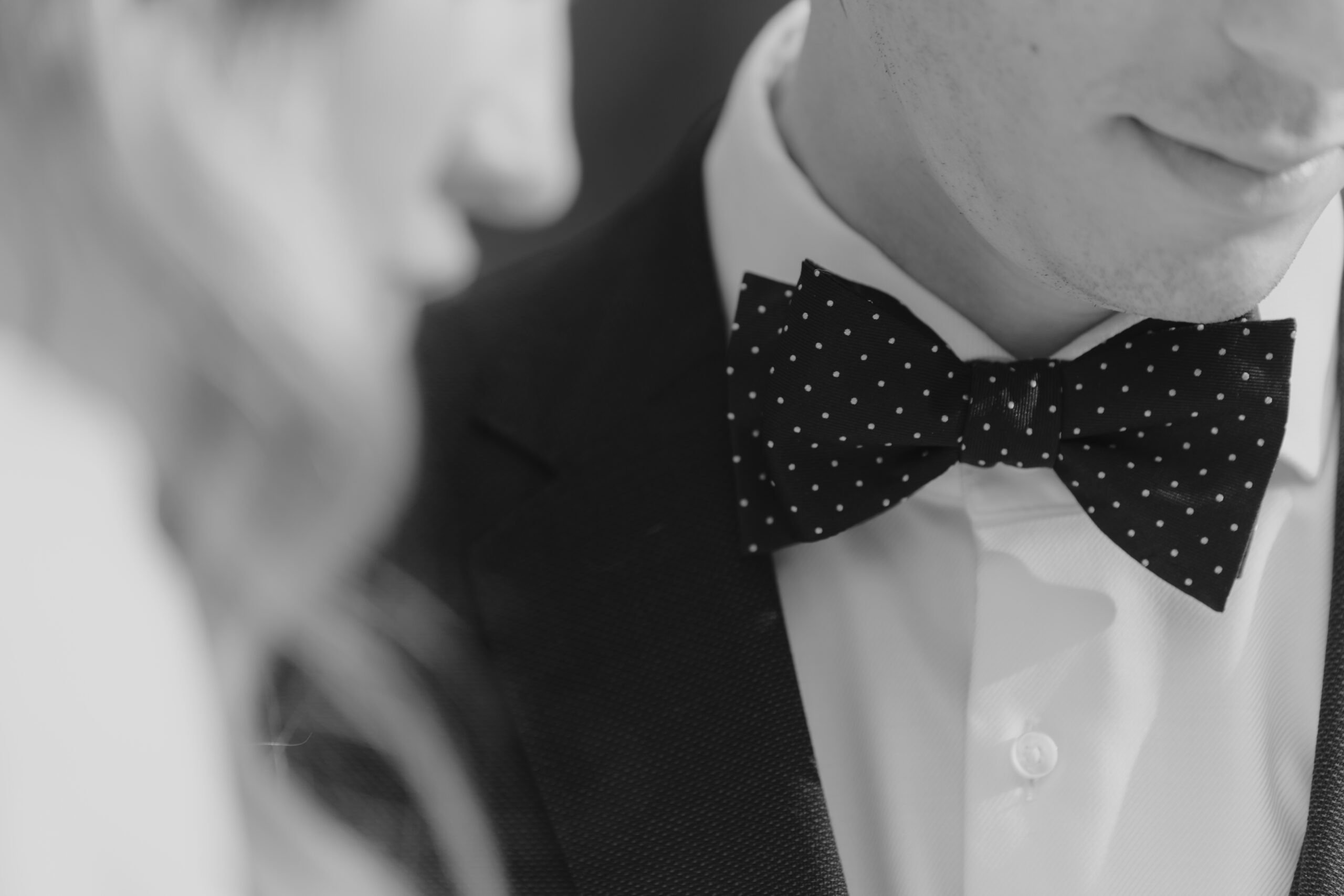 A black and white photo of a man wearing a bow tie during an elopement in Seoul.