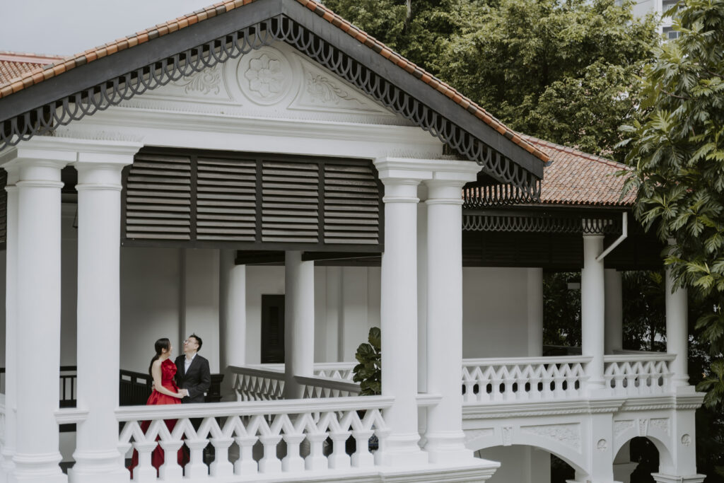 A couple at Raffles Hotel balcony in Singapore.