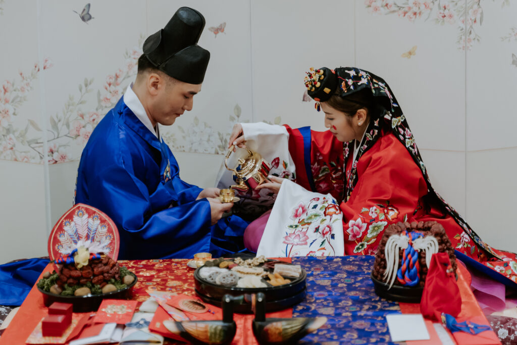 bride and groom serve each other at their pyebaek ceremony in Seoul