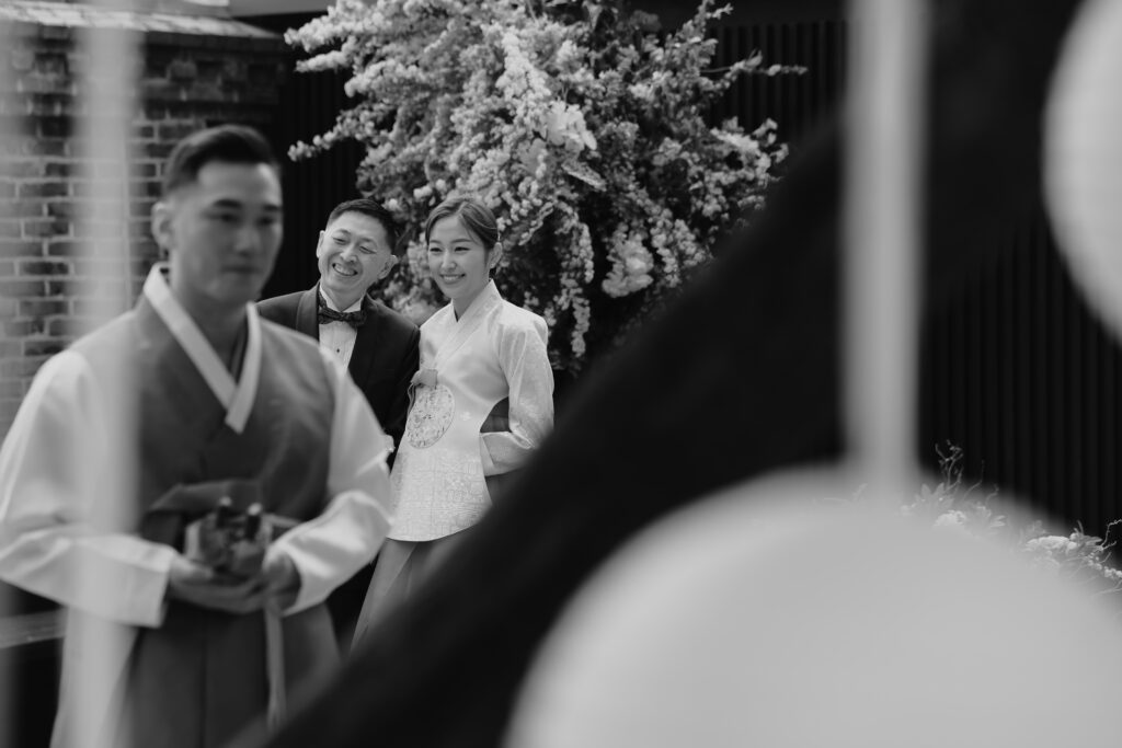 bride and father about to walk down the aisle at a korean traditional wedding.
