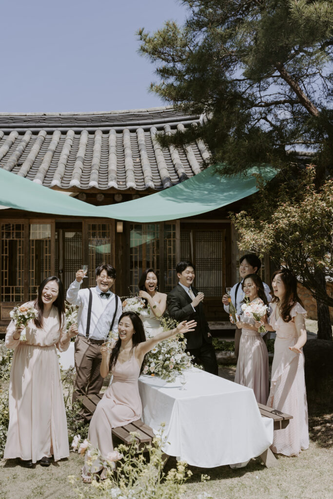 A group of korean bridesmaids posing in front of a hanok house in south korea