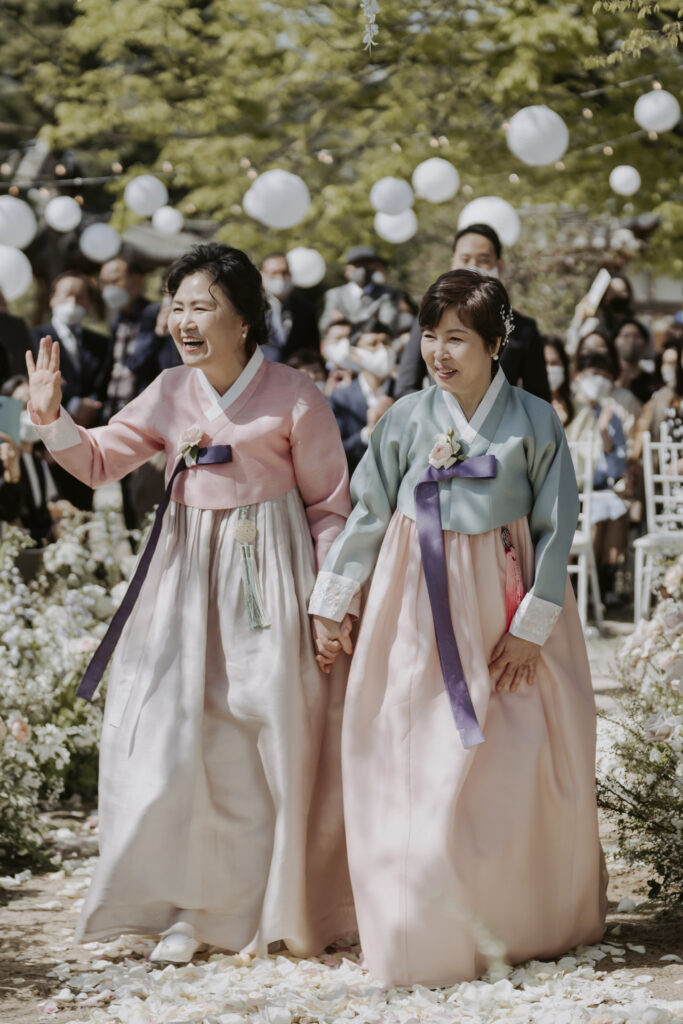 Two korean mother walking down the aisle.