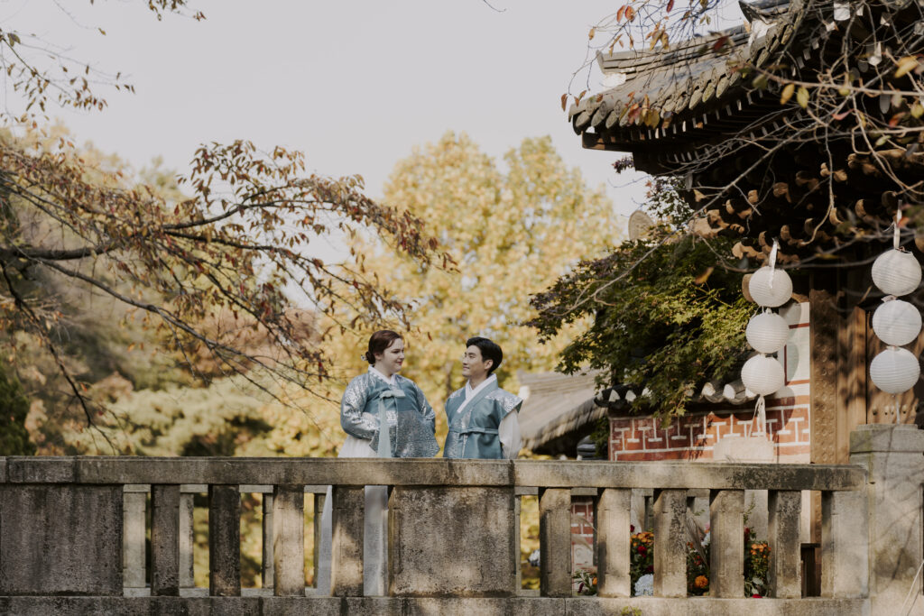 A bride and groom standing on a bridge at Sunwoongak Seoul.