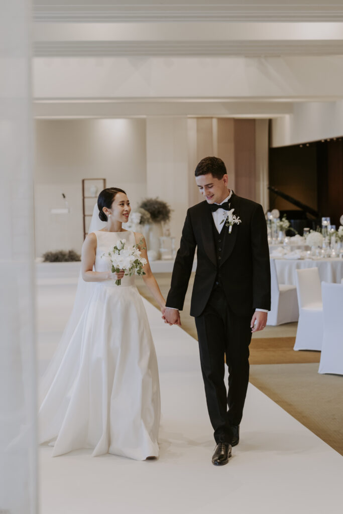 A bride and groom walking down the aisle at their Seoul Destination Wedding.