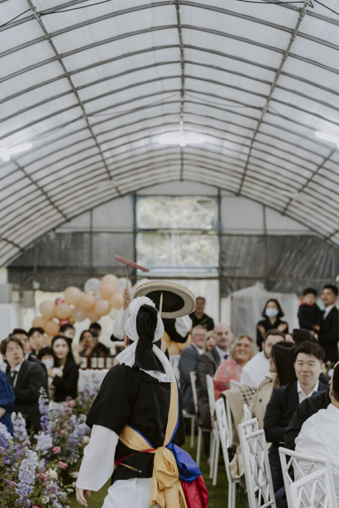 A woman doing a Korean traditional dance at a wedding.