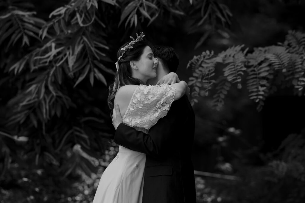 A bride and groom kissing in a garden after their first look in Korea.