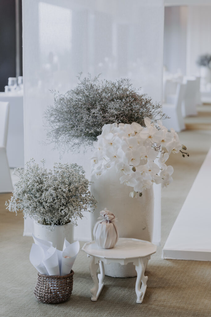A white table with flowers on it.