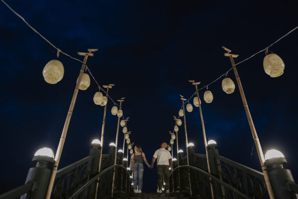A couple's damyang pre-wedding shoot featuring a romantic walk on a bridge at night.
